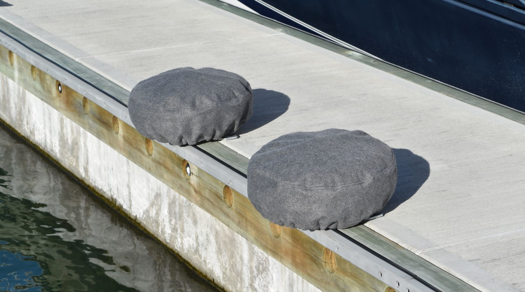 Fleece covered PVC dock wheel covers, the best option for boats with a vinyl wrapped hull.  For marina berths, available from Hauraki Fenders