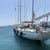 Customer photo of Hauraki inflatable fenders, covers and other products in use. White sailboat docked in clear blue water with a clear sky